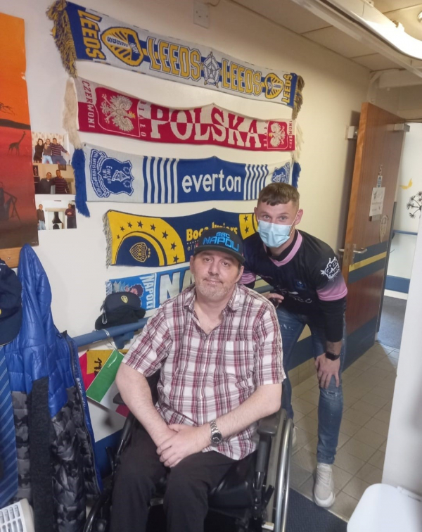 Residents enjoy a kick about with local footballer
